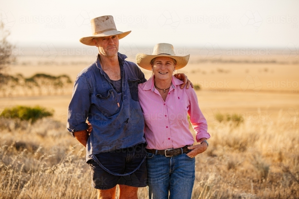 Farming couple wearing hats on their rural property - Australian Stock Image