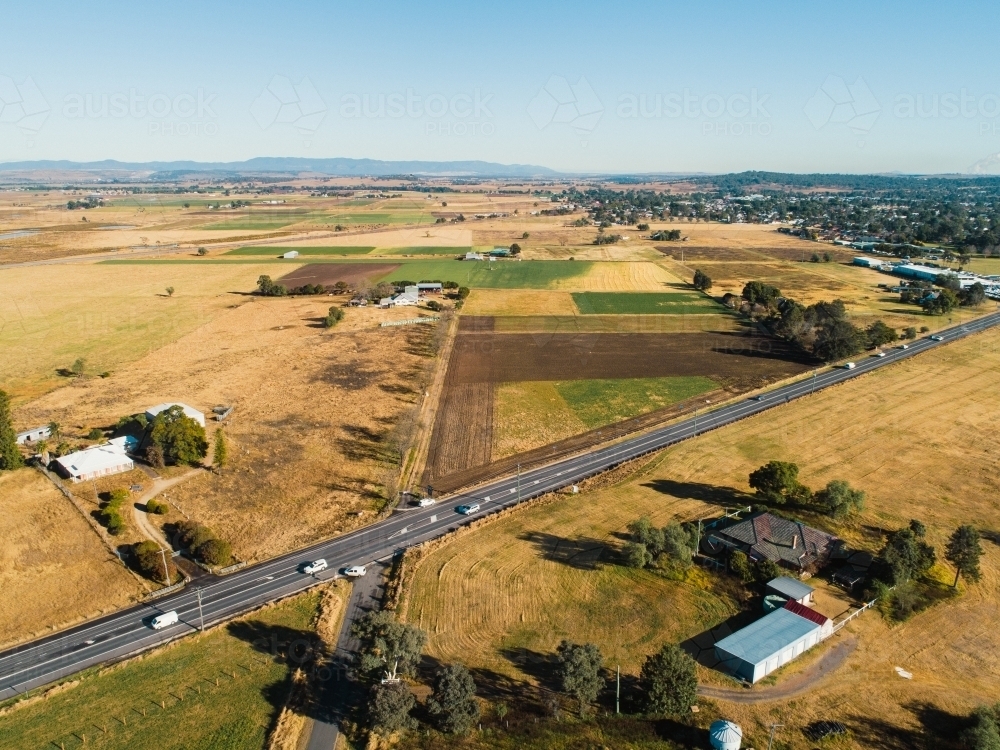 farmland outside Singleton before the bypass with traffic on New England Highway - Australian Stock Image