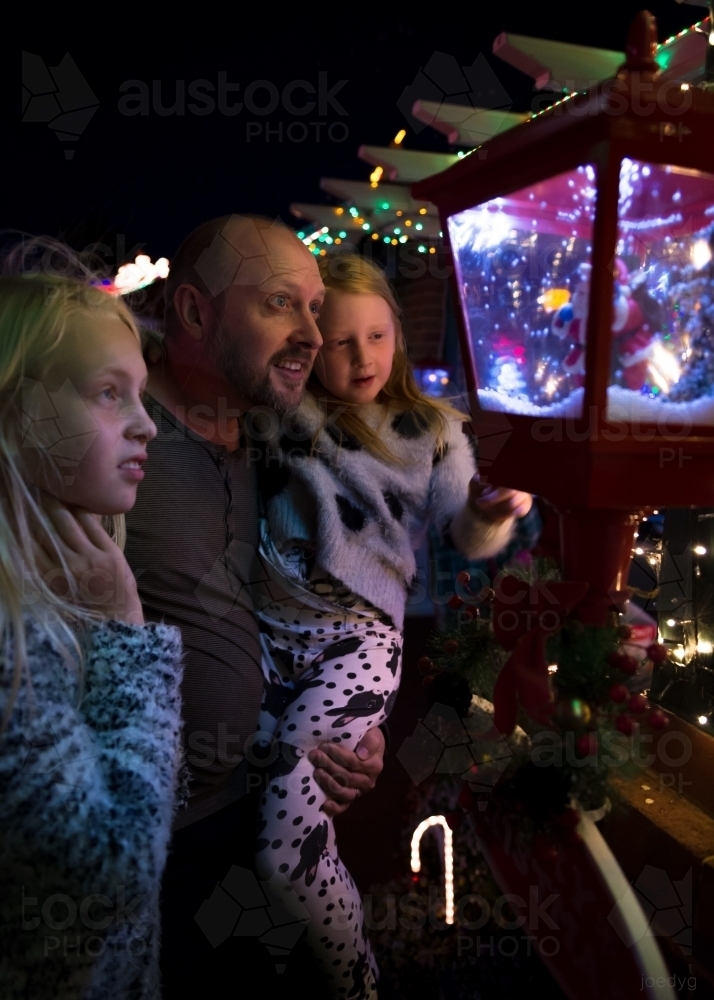 Father and Daughters Looking At Christmas Lights - Australian Stock Image