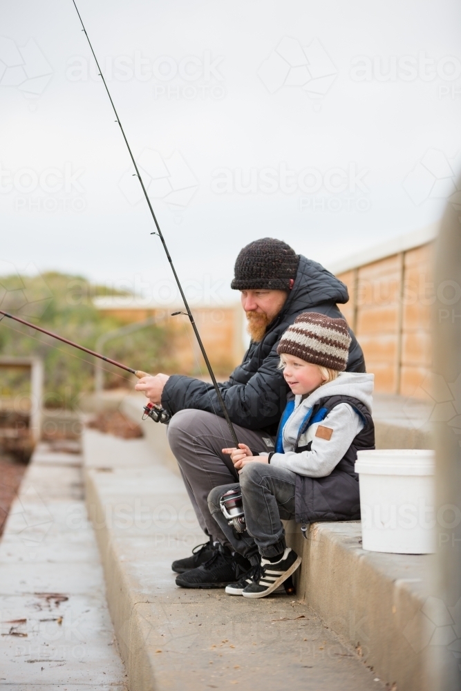 Father and Son fishing in winter - Australian Stock Image