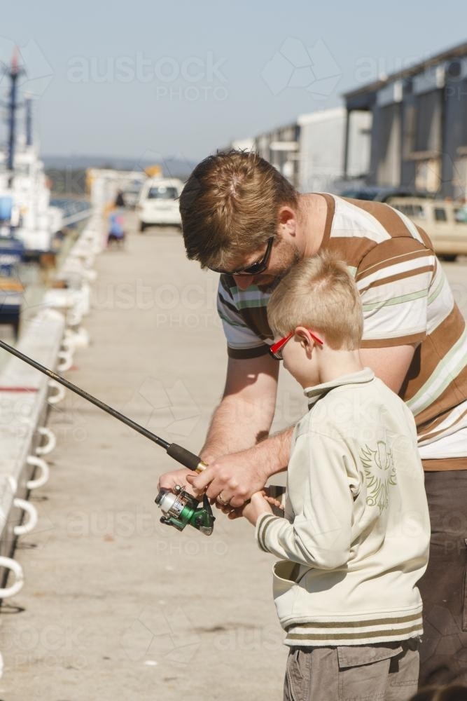 Father and son fishing on a sunny day - Australian Stock Image