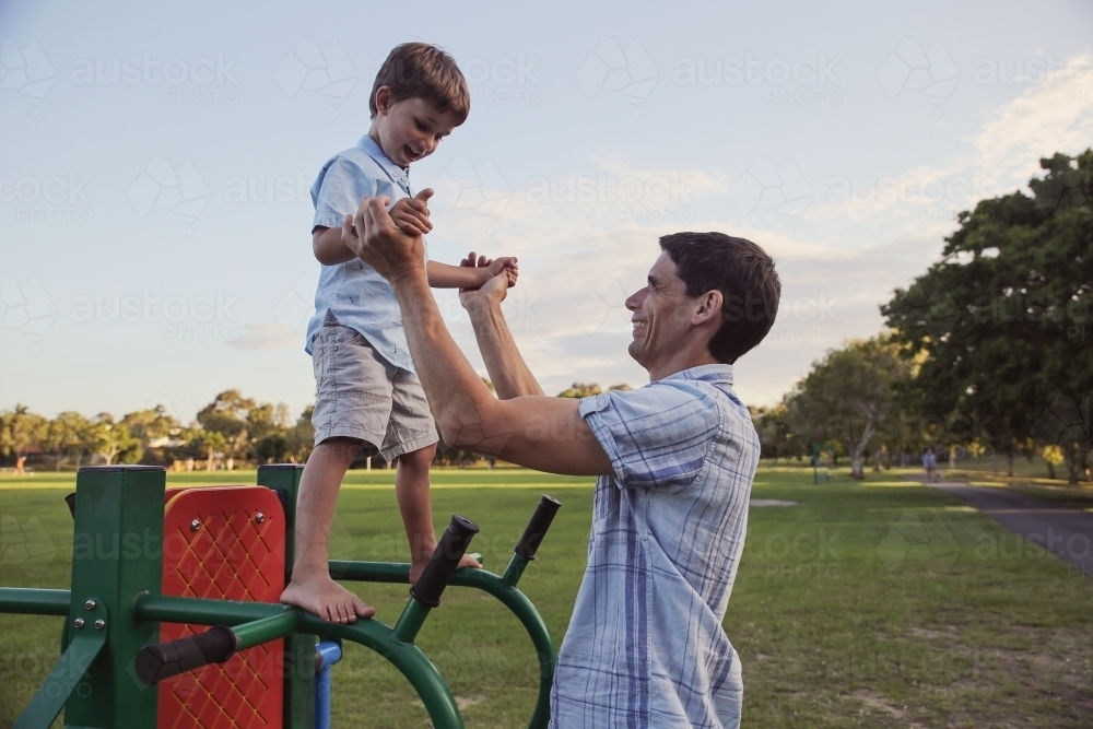 Father and son playing at the park - Australian Stock Image