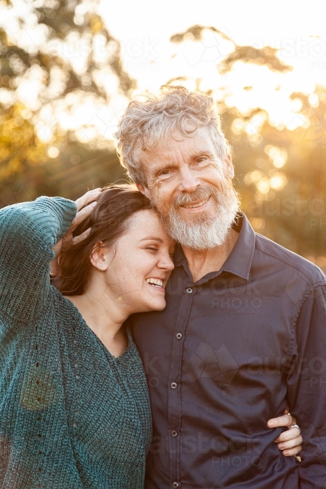 Father with daughter in afternoon light - Australian Stock Image