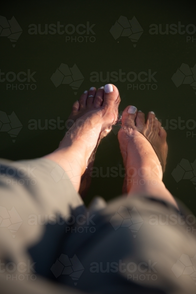 Feet cooling down in river - Australian Stock Image