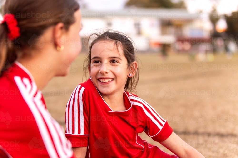 image-of-female-football-players-sitting-on-the-grass-taking-a-break