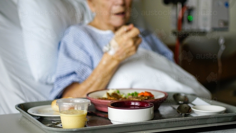 Female patient eating hospital food - Australian Stock Image