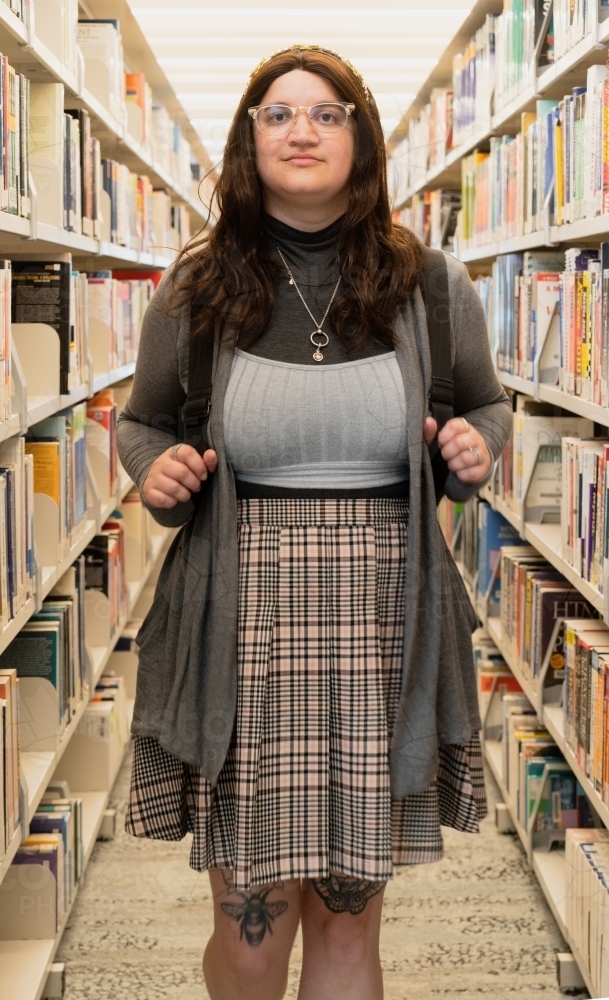 Image of Female Student Facing Viewer while Standing between Library ...