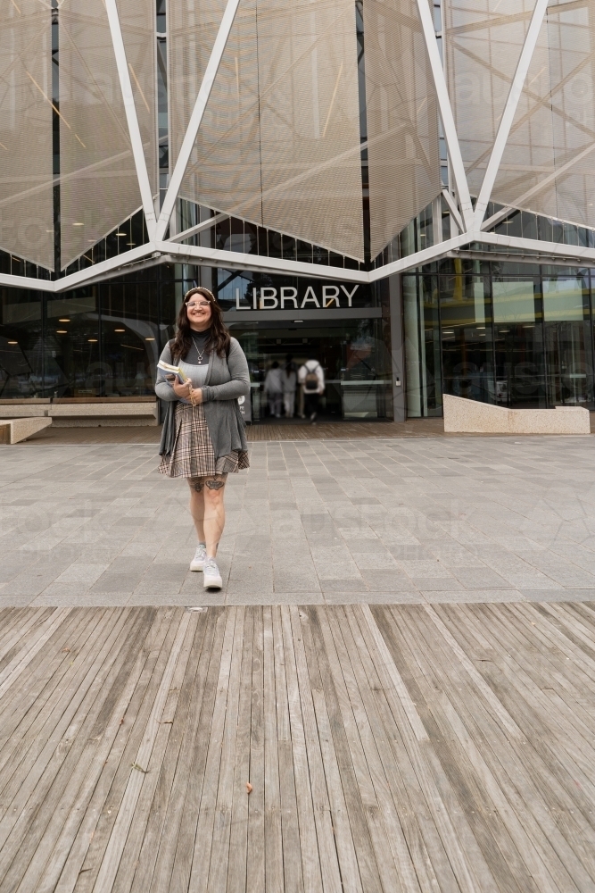 Female Student in Front of Campus Building Walking Towards Viewer - Australian Stock Image