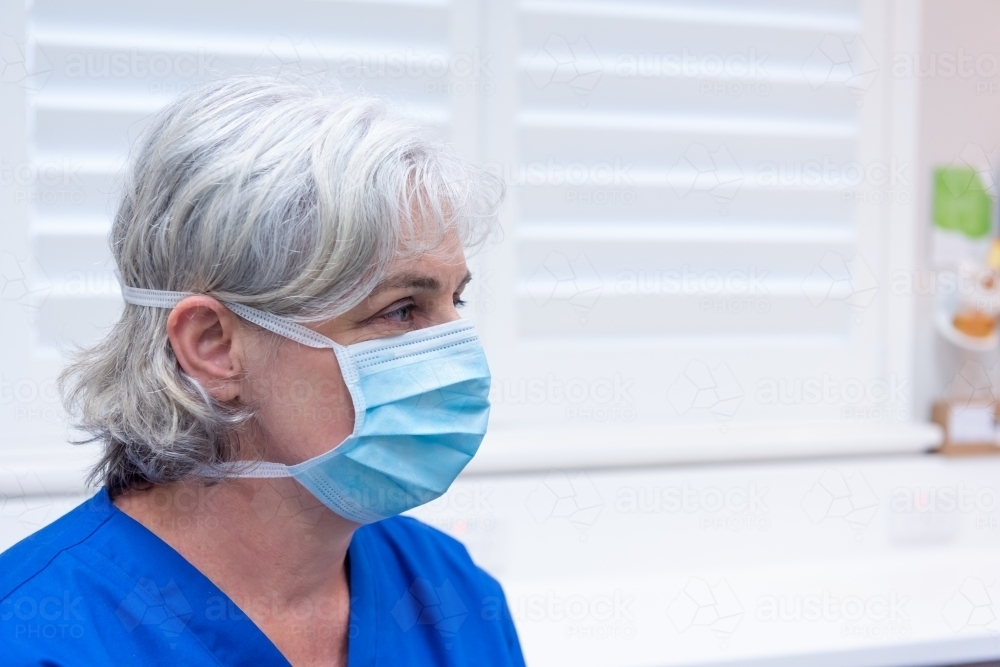 Female wearing surgical mask - Australian Stock Image