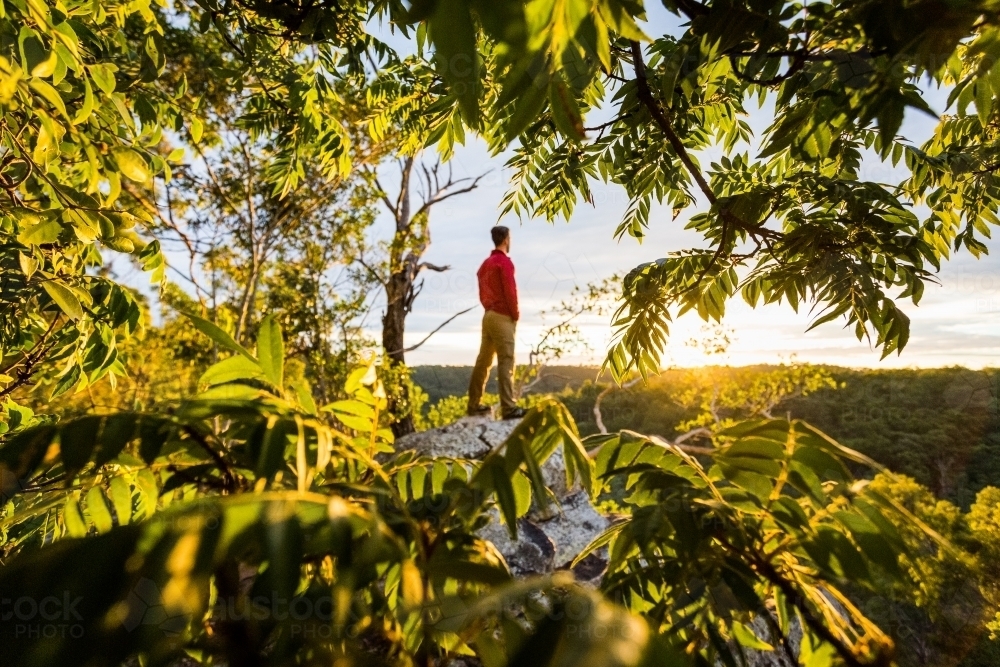 figure on rock at sunrise - Australian Stock Image