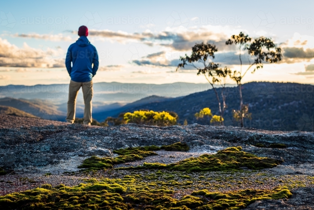 Figure overlooking mountain view - Australian Stock Image