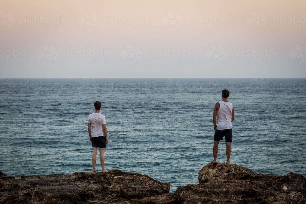 Figures overlooking the ocean - Australian Stock Image