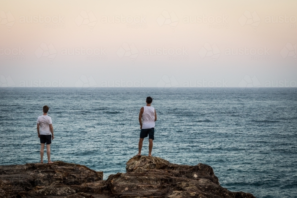 Figures overlooking the ocean - Australian Stock Image