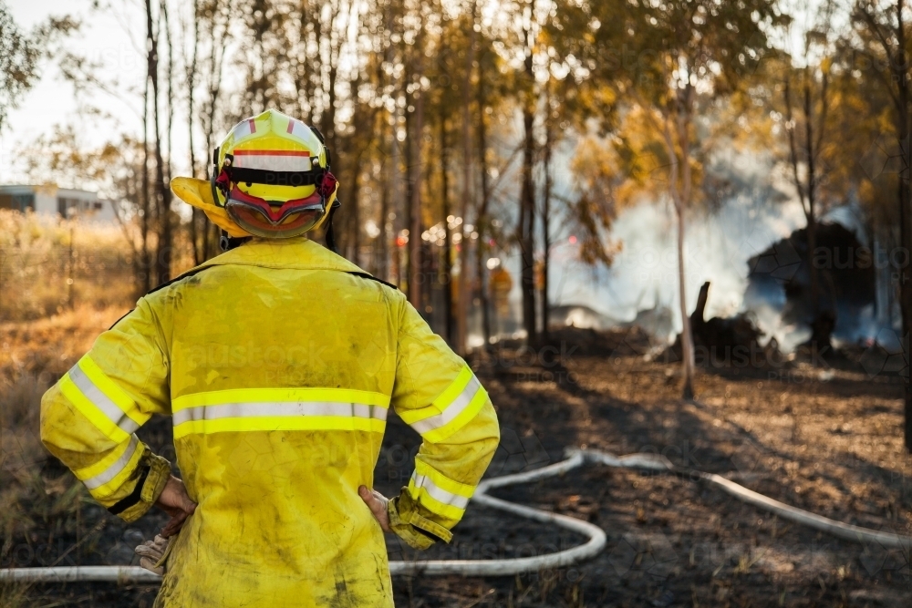 Fire and rescue man in fire brigade out at a grass fire emergency site - Australian Stock Image