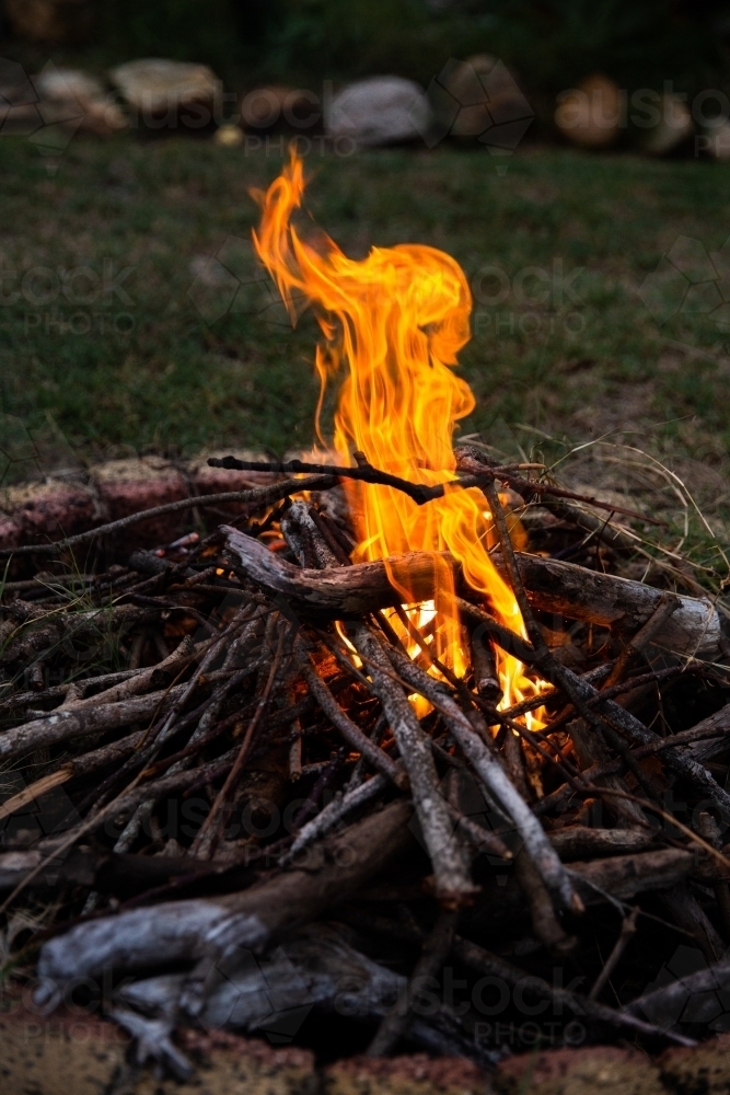 fire in a backyard fire pit - Australian Stock Image