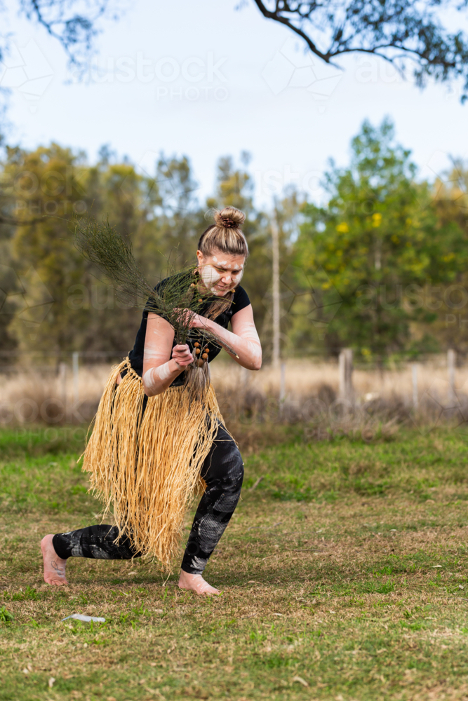 First nations Australian woman dancing to aboriginal music during welcome to country ceremony - Australian Stock Image