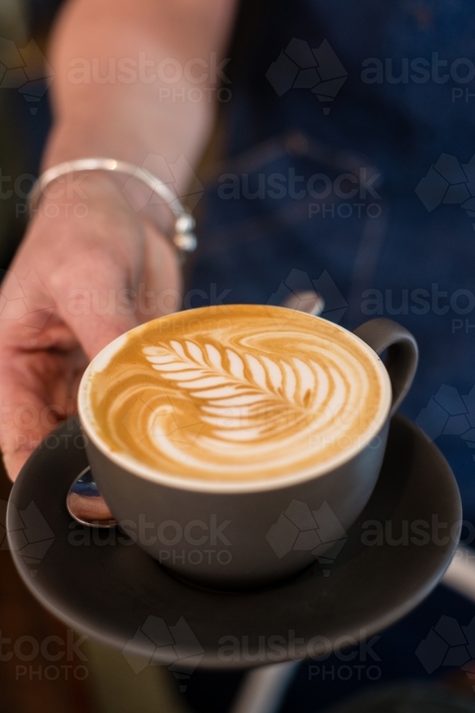 flat white with pretty coffee art rosetta - Australian Stock Image