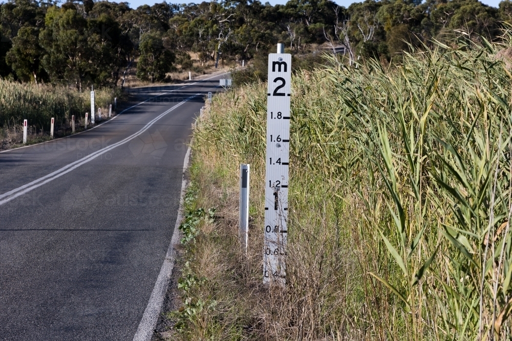 Flood Marker on regional road - Australian Stock Image