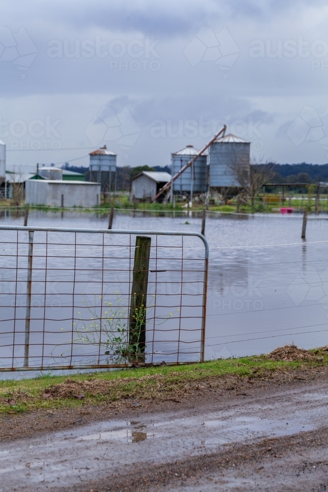 Flood natural disaster event on farm water covering paddock - Australian Stock Image