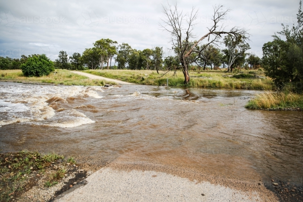 Flooded river crossing on farm - Australian Stock Image