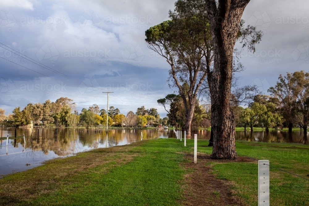 flooded road and golf course underwater on rainy day - Australian Stock Image