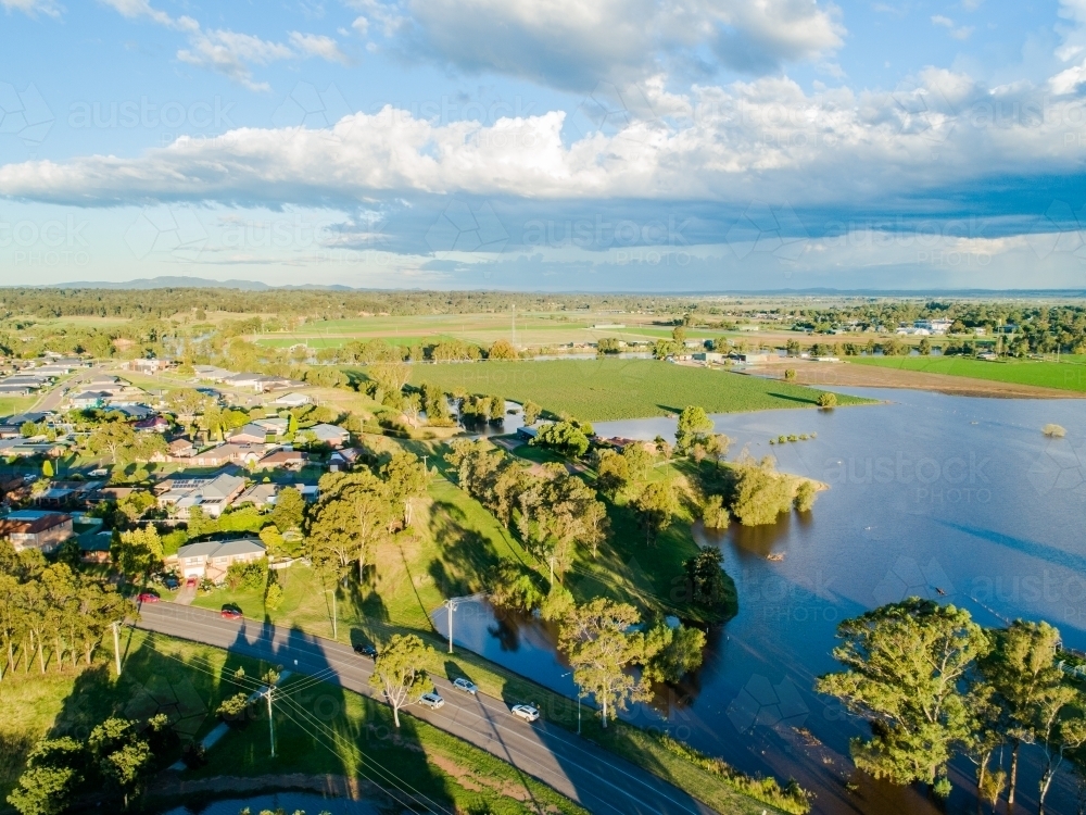 Flooding farm paddocks and distant rain and storm clouds - Australian Stock Image