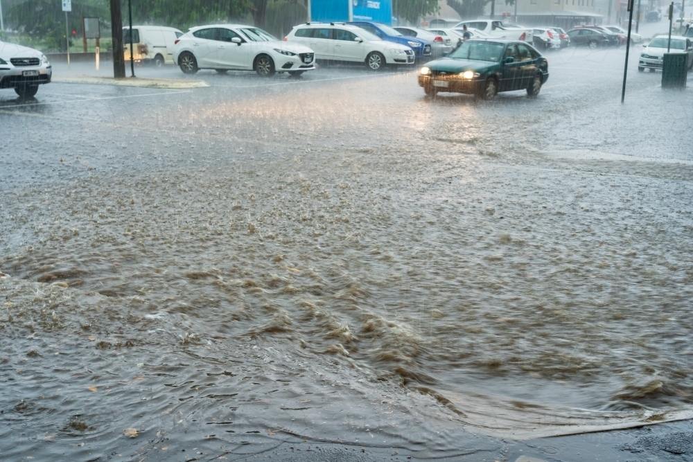 Flooding rain crossing a city street - Australian Stock Image