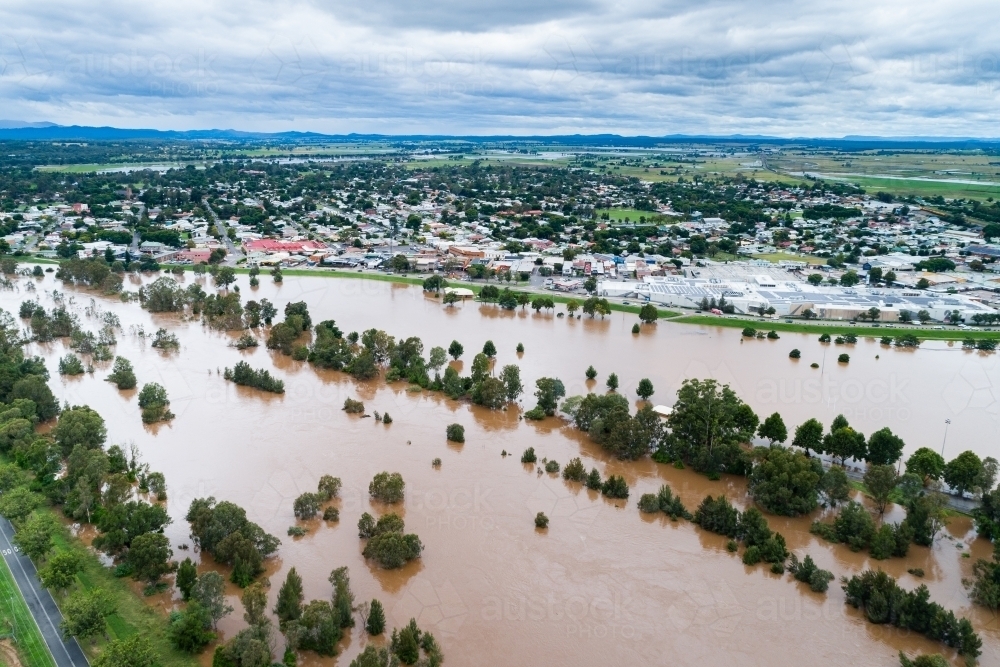 Image of Flooding river with floodwaters reaching up the levee bank ...