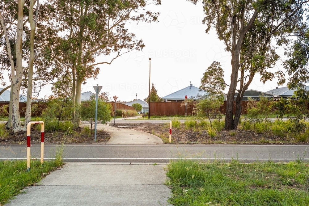 Footpath crossing road in green strip between neighbourhoods - Australian Stock Image