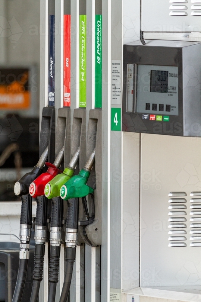 Image of Four fuel nozzles at petrol pump bowser. - Austockphoto