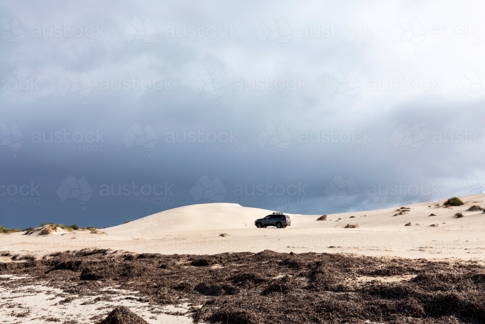 four wheel drive driving through sand dunes - Australian Stock Image