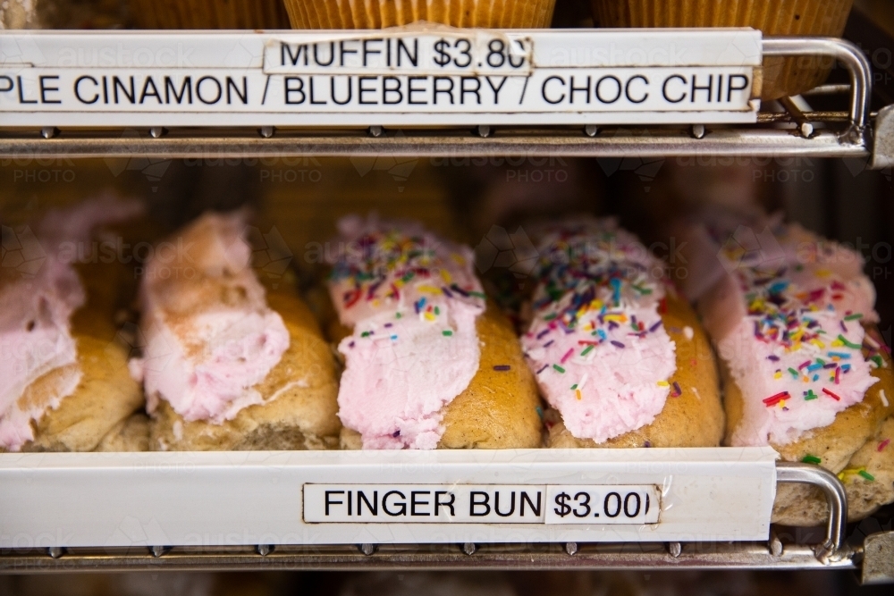 fresh finger buns for sale at a bakery - Australian Stock Image