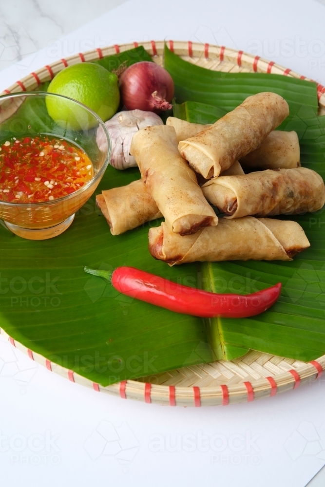 Freshly cooked Filipino food called Lumpiang Shanghai or fried pork spring rolls. - Australian Stock Image