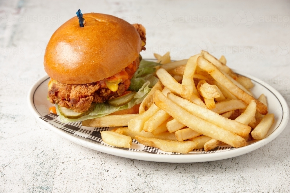 Fried chicken burger and chips - Australian Stock Image