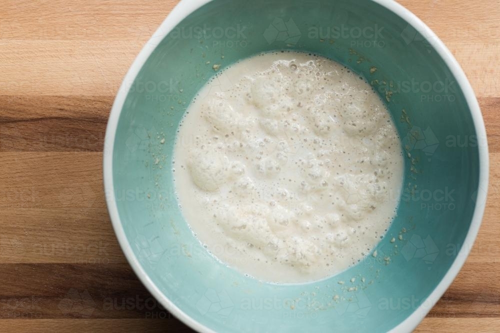 Frothy yeast in a bowl for baking bread - Australian Stock Image