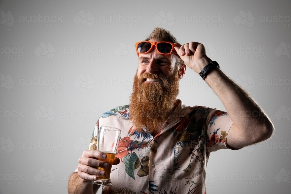 Funky, guy, man holding a glass of beer - Australian Stock Image