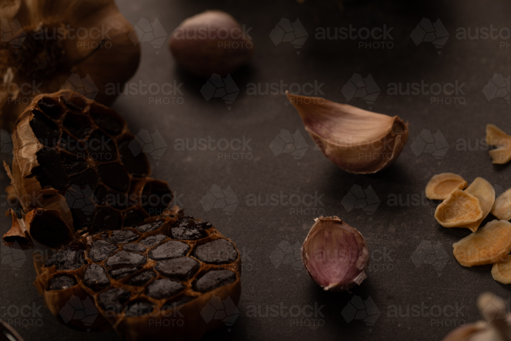Garlic bulb cut in half to show smoked cloves - Australian Stock Image