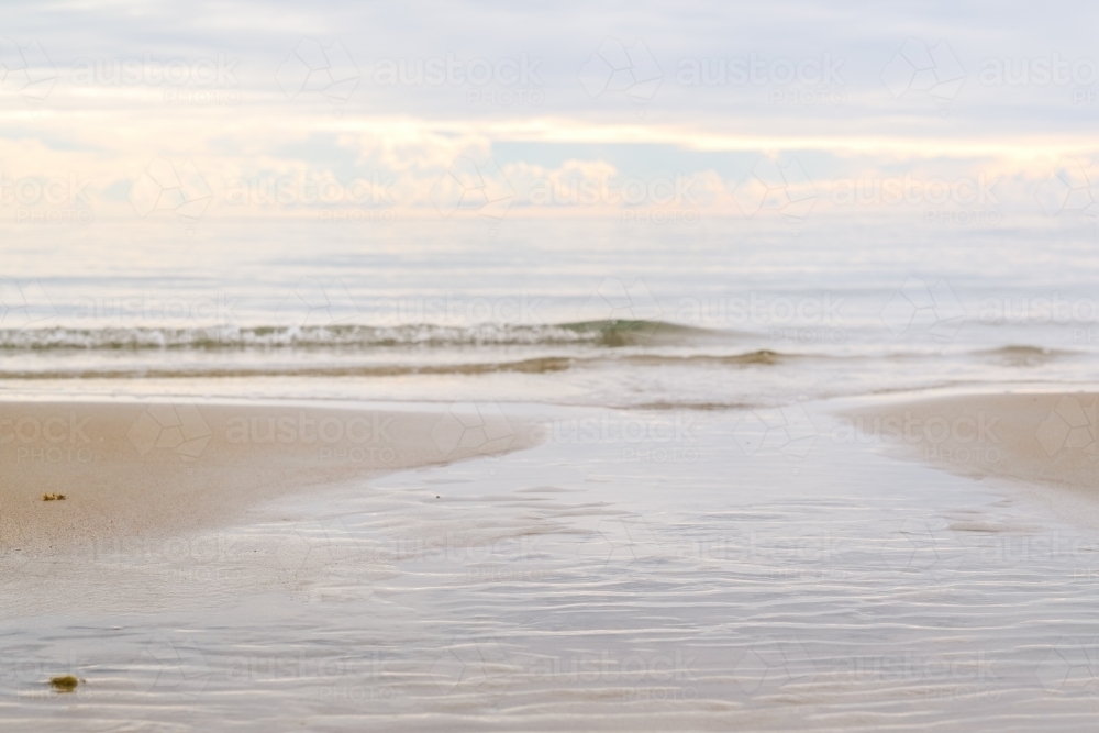 gentle morning waves touching the shore - Australian Stock Image