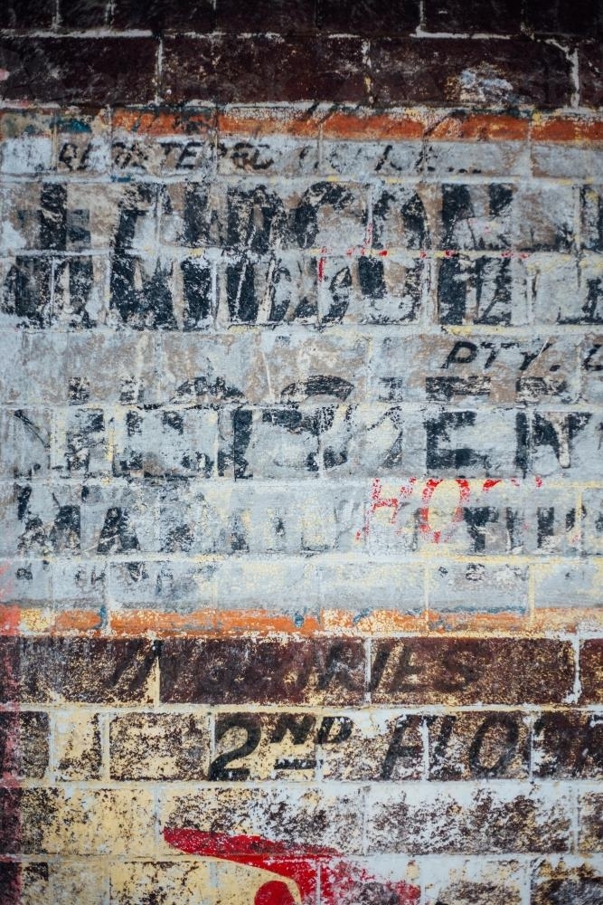 Ghost signage on brick wall - Australian Stock Image