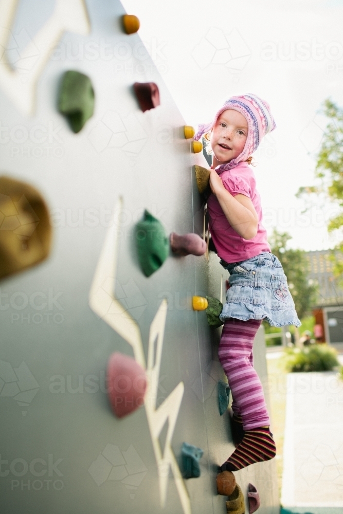 Girl climbing an outdoor rockclimbing wall - Australian Stock Image