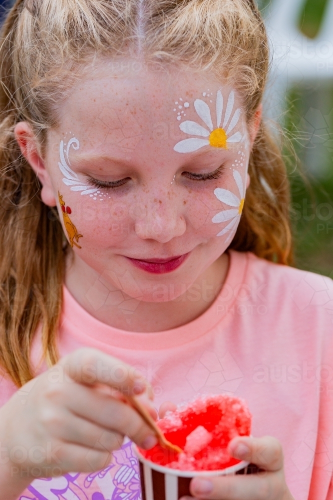 Girl eating shaved ice treat at Australia Day event – snow cone - Australian Stock Image