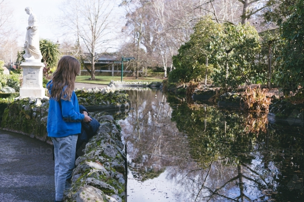 Girl looking into reflections at Ballarat Botanical Garden - Australian Stock Image