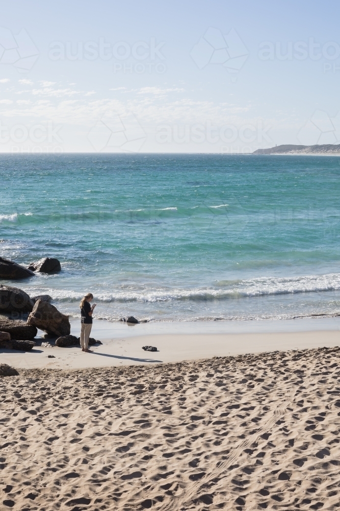 Girl photographing regional australian beach - Australian Stock Image