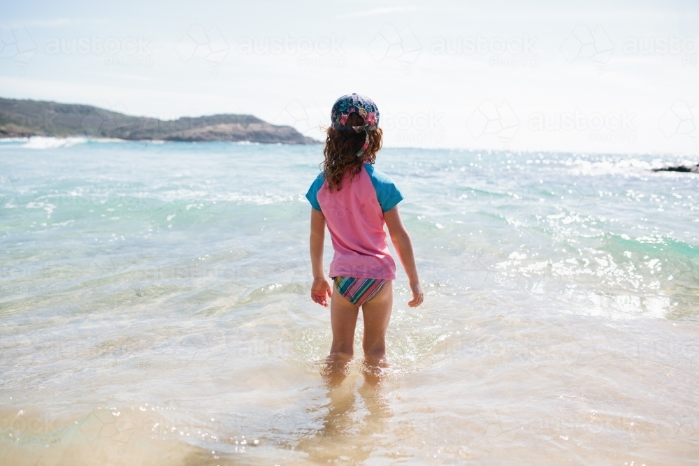 Girl standing in the water at the beach - Australian Stock Image