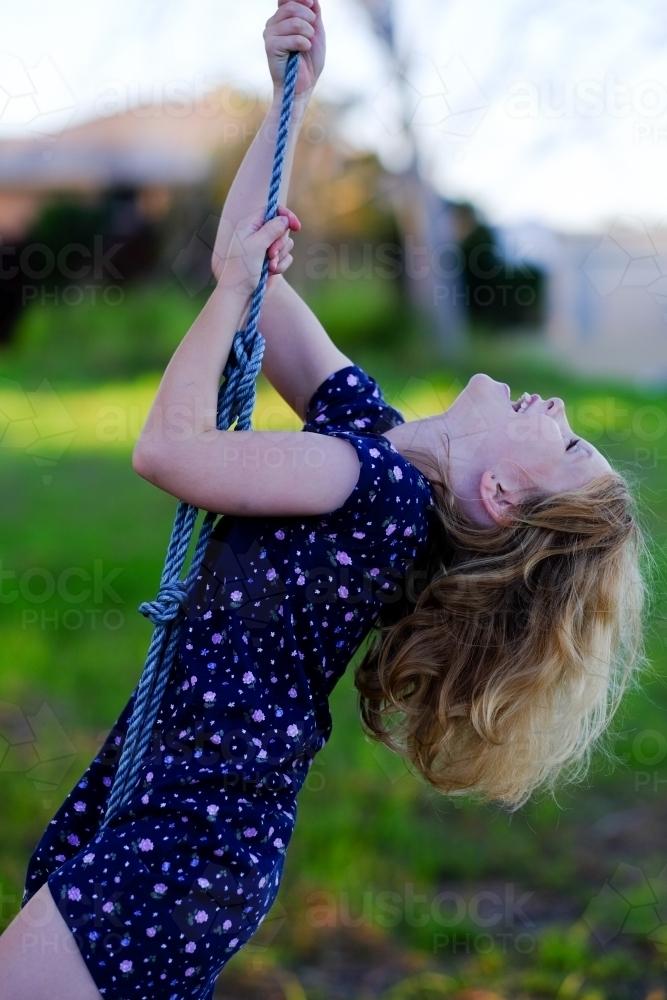 Girl swinging on a rope - Australian Stock Image