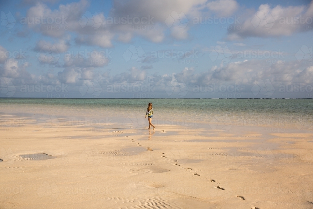 girl walking on the beach in the morning - Australian Stock Image