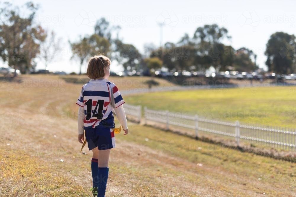 girl wearing rugby league jersey at an oval - Australian Stock Image