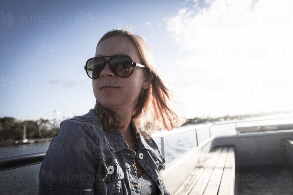 Girl wearing sunnies boat - Australian Stock Image