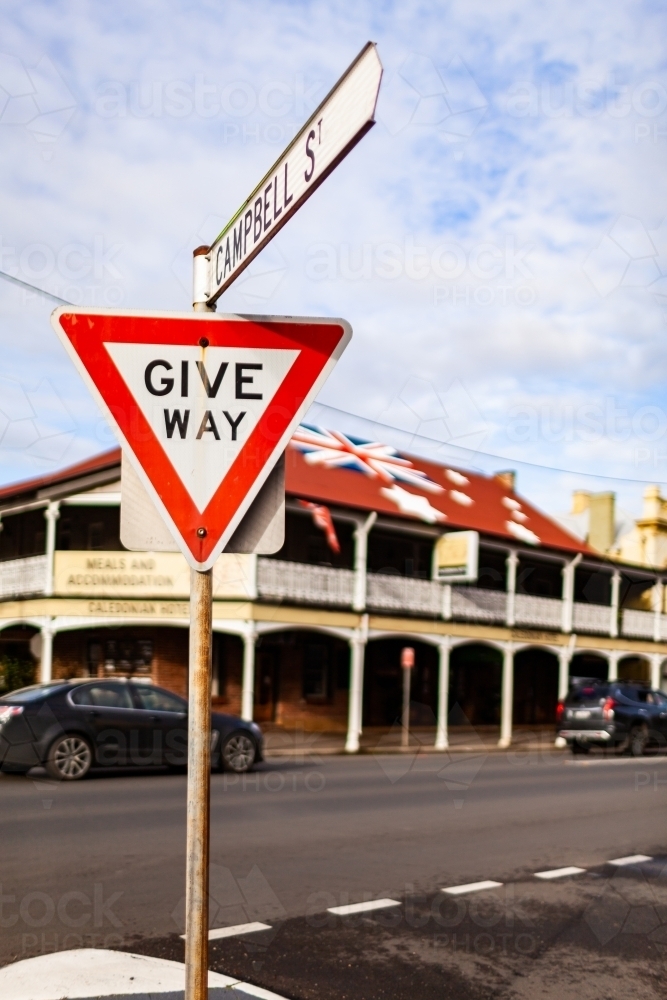 Give way street sign at intersection of side road with main street in Aussie town - Australian Stock Image