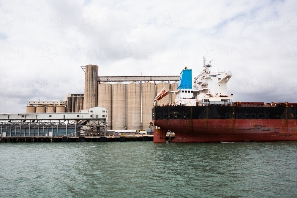 Gladstone Harbour from the water with silos and ships - Australian Stock Image